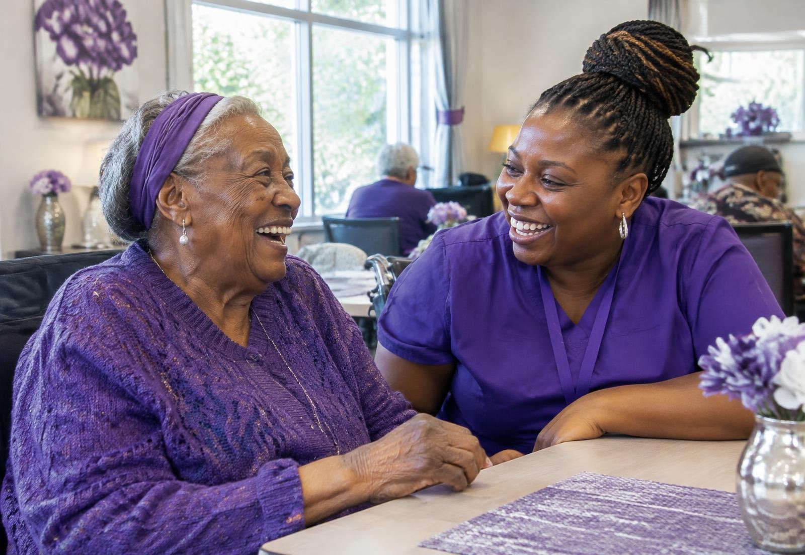 A caregiver sharing a joyful moment with a senior